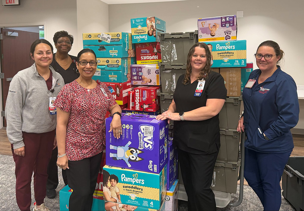 HCA Team members pose with diaper donations.