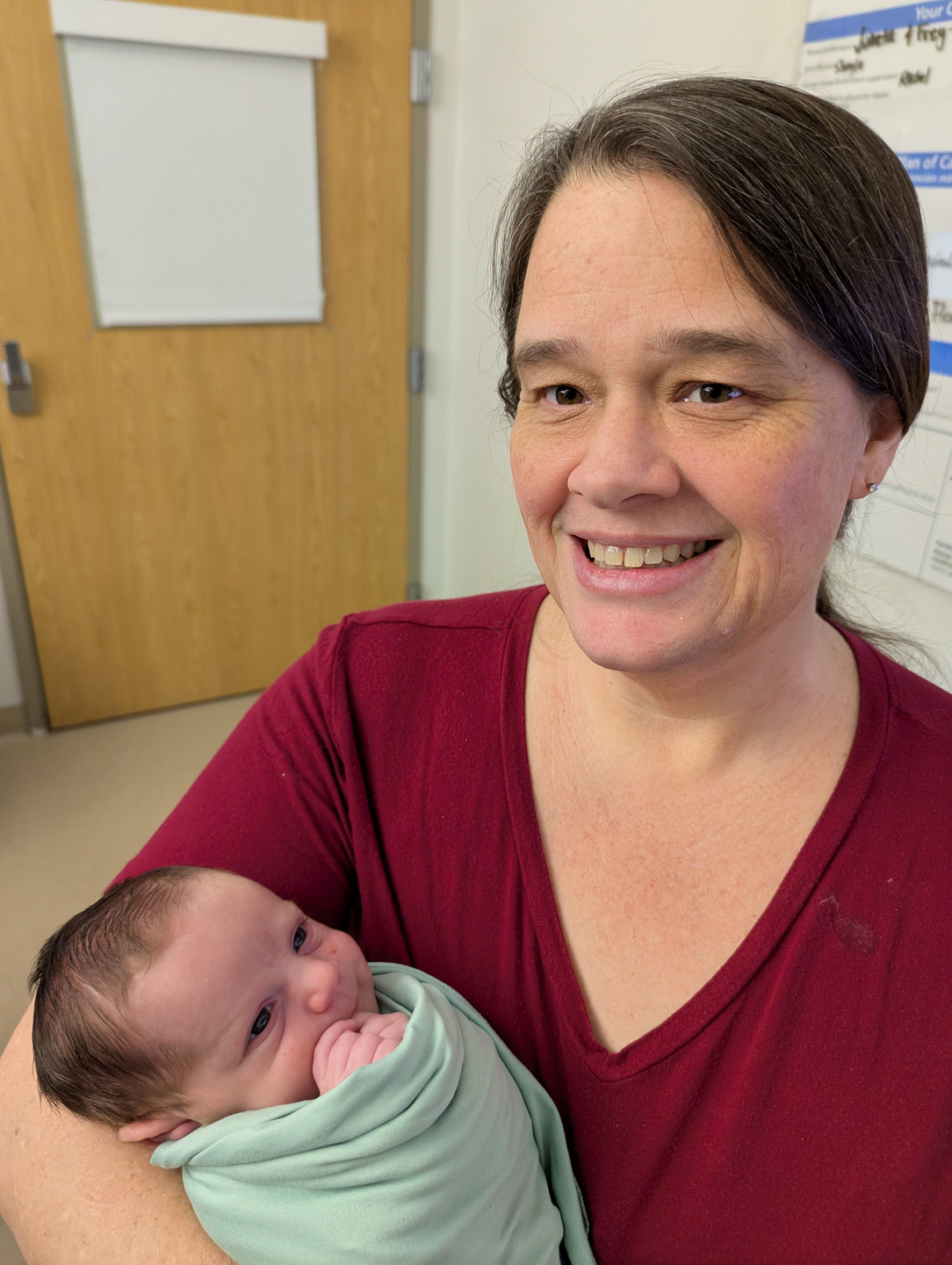 Lanna in red shirt and newborn baby August.