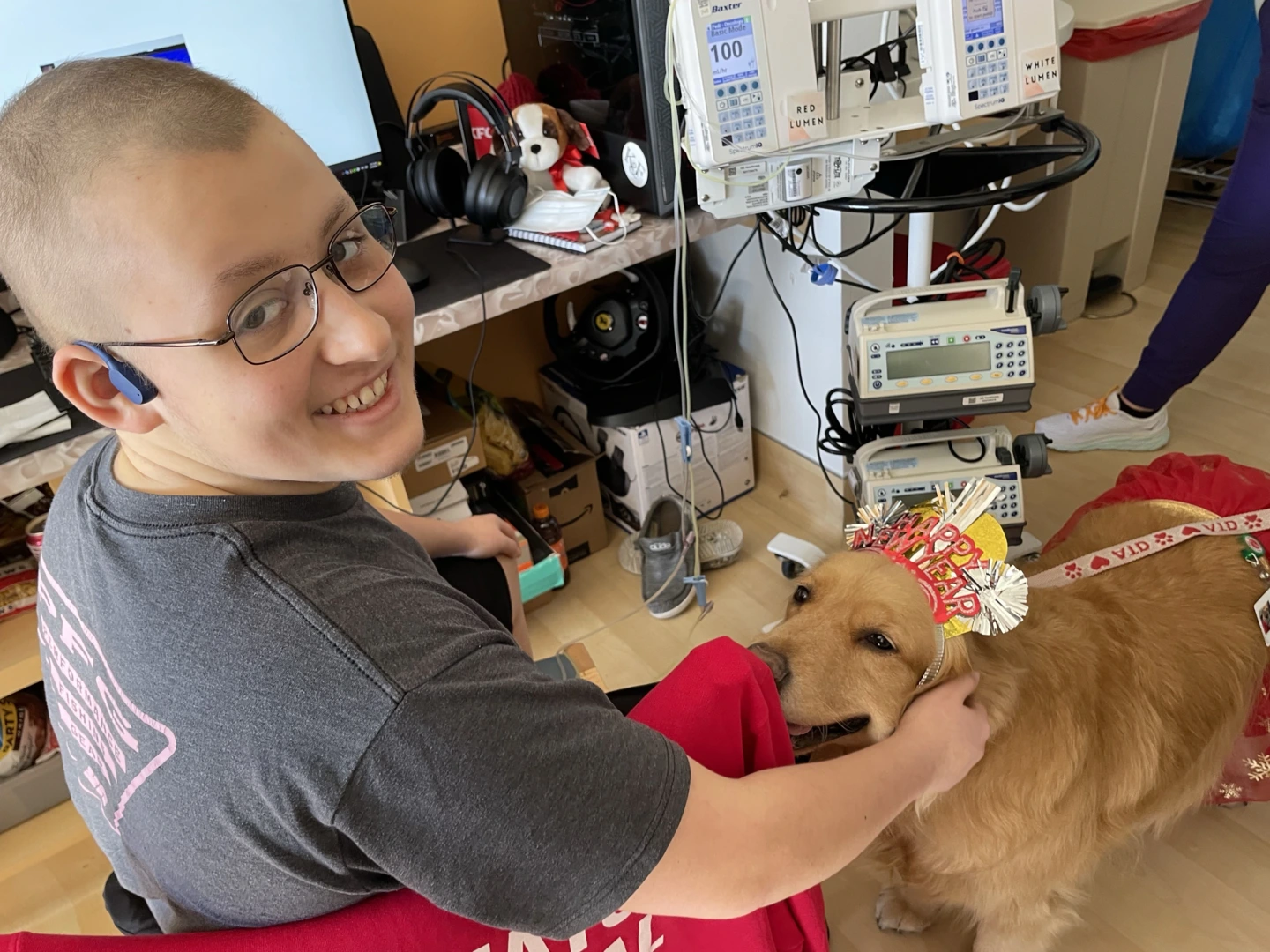 Tyler petting a dog at the hospital.