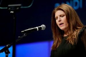 Lori Frisher speaking at microphone