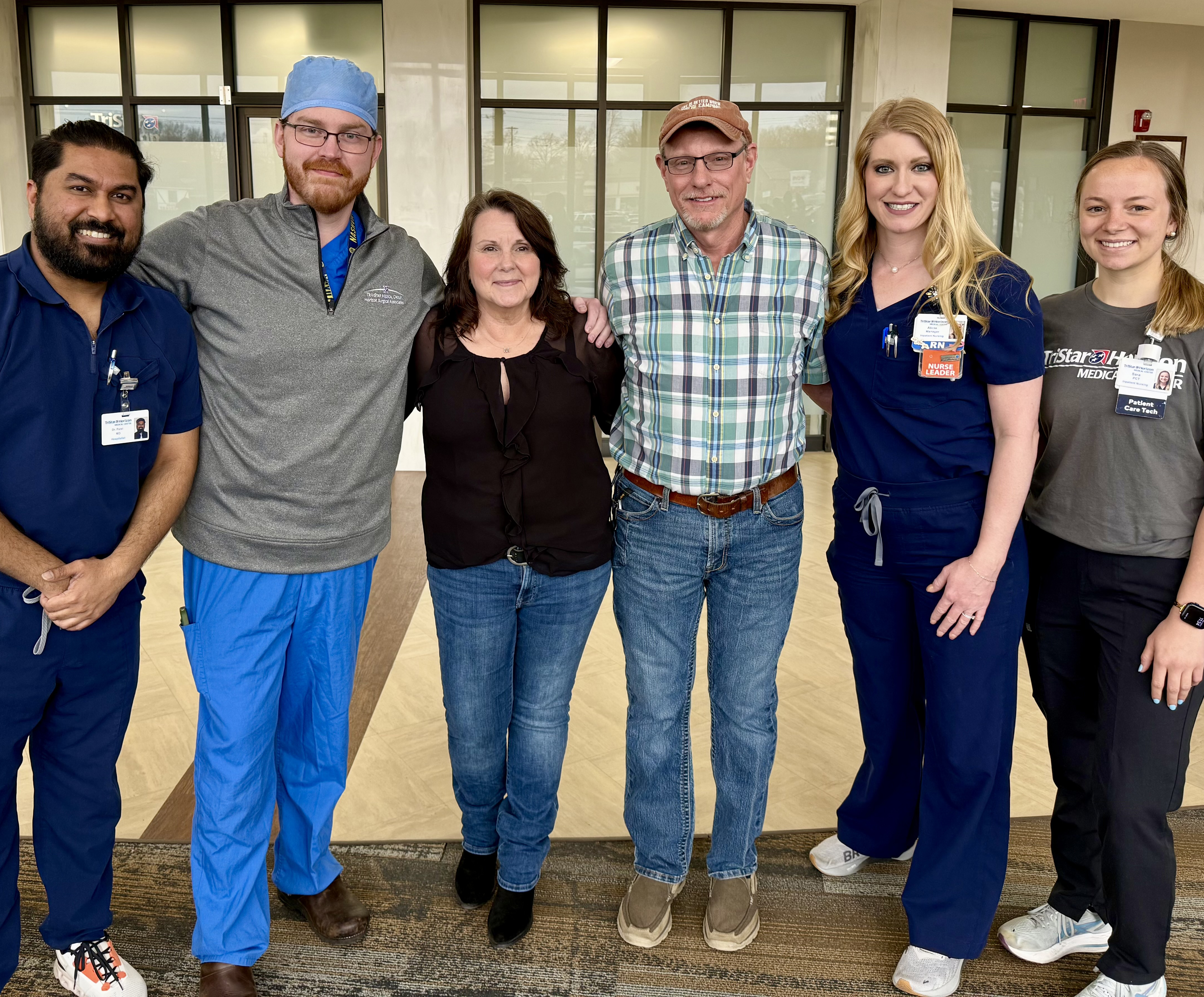 Dr. Patel, Dr. Jones, Rebecca, Darrin, Alicia, and Sara smiling and posing for a photo together