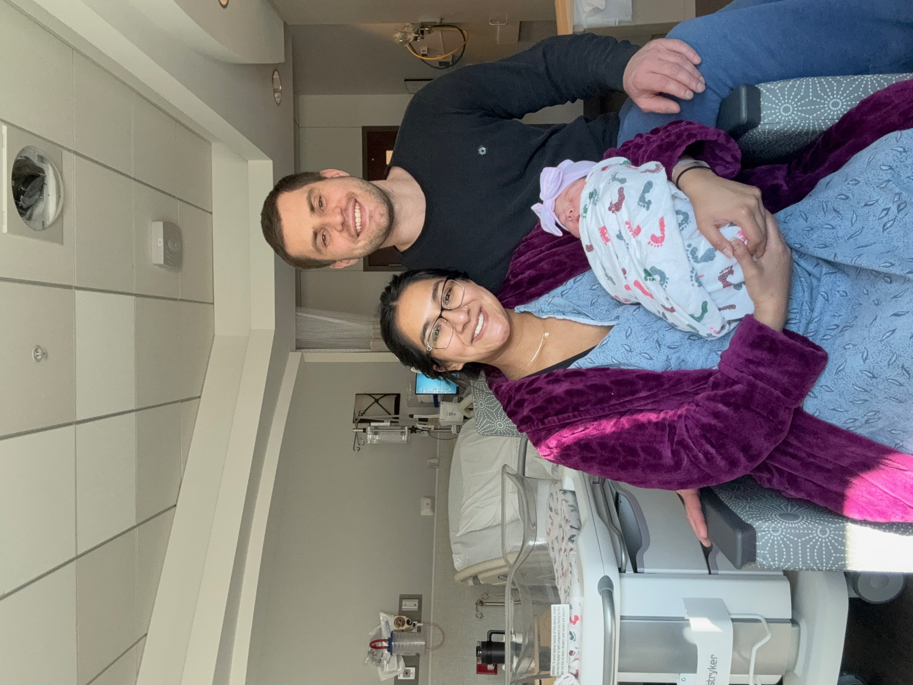 Anthony and Mariel posing with newborn Londyn.