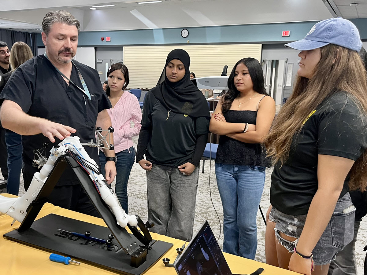The students learn about one of our surgical robots.