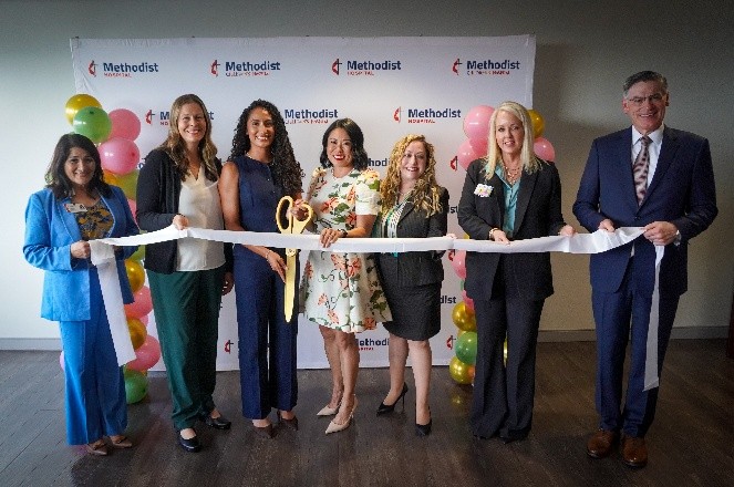 Leadership from Methodist Hospital and Methodist Physicians, Women's Services and Midwifery Clinic pose for a ribbon cutting photo.