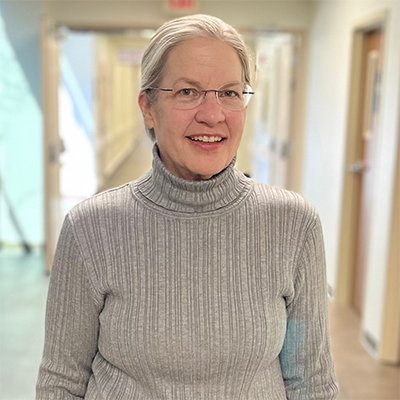 Laura wearing a gray turtleneck.