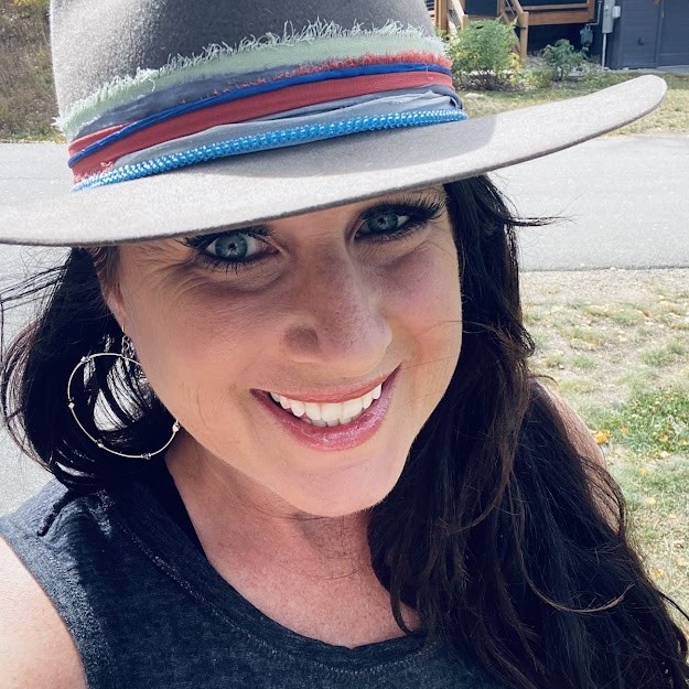 Jessica Sidener outside in the sun, smiling.
