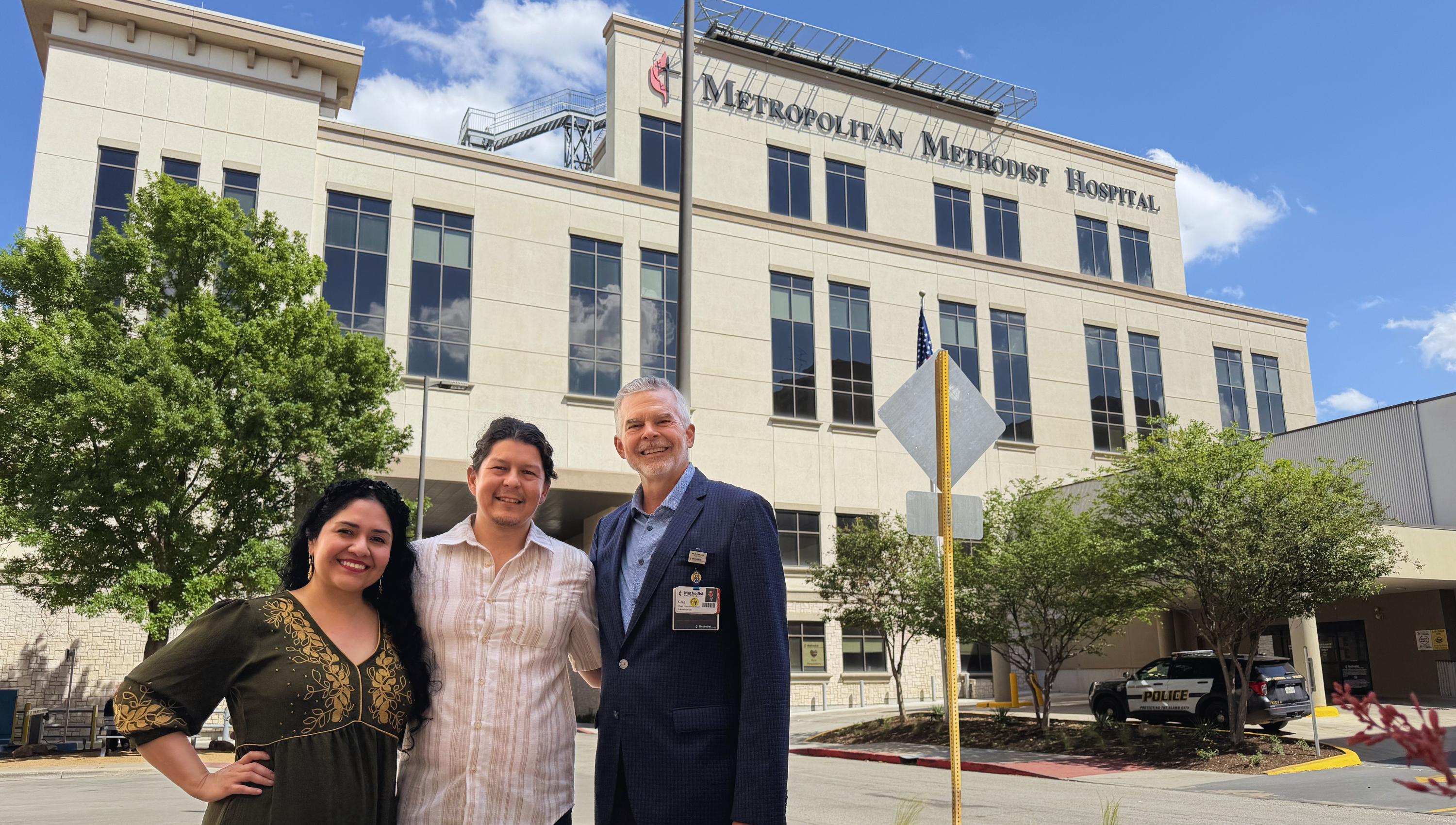 From left to right: Sandra Gonzalez, Malachy Mckinney, and Greg Seiler stand in front of Methodist Hospital Metropolitan