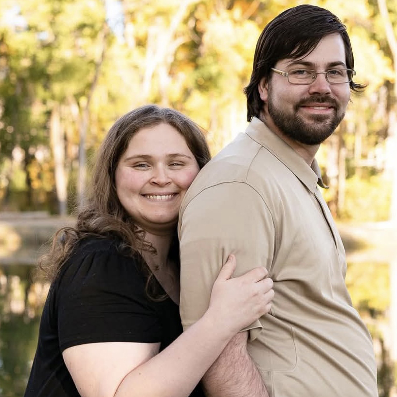 St. Mark's Hospital patient, Emily Ketchum, embraces her husband from behind. Both are smiling.