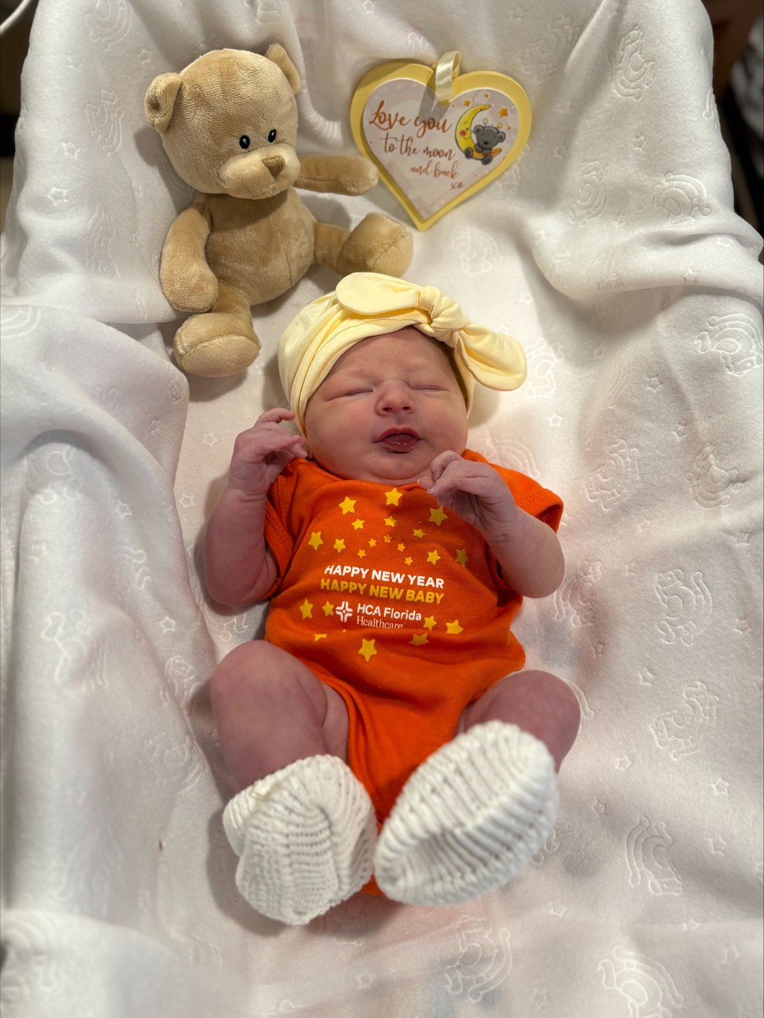 Amara May Fuller in her crip with teddy bear.