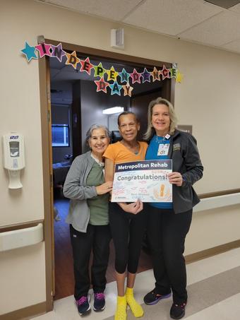 Claudette Dunnaway with two women under sign reading "Independence Day."