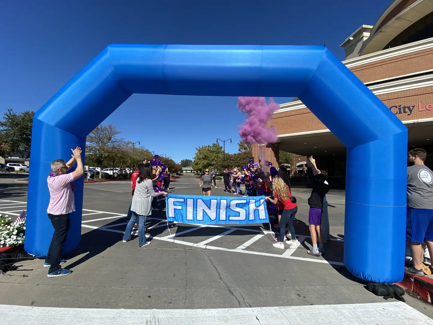 Group cheering on Alexis at finish line