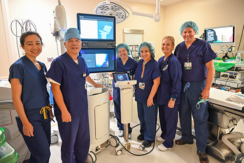 The multidisciplinary team at Good Samaritan Hospital that took part in Robotic Assisted Navigation Bronchoscopy proudly stand together in a hospital room.