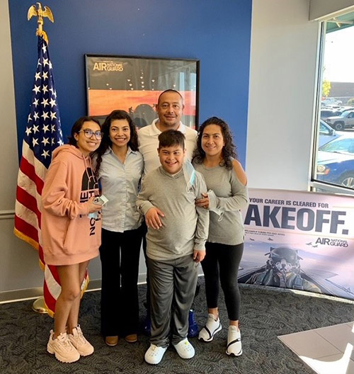 Linda smiles while standing with her family on the day she enlisted in the Air National Guard.