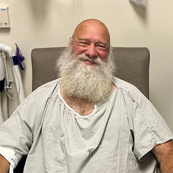 Lynn Hulse wearing a hospital gown, waiting to go in for surgery.
