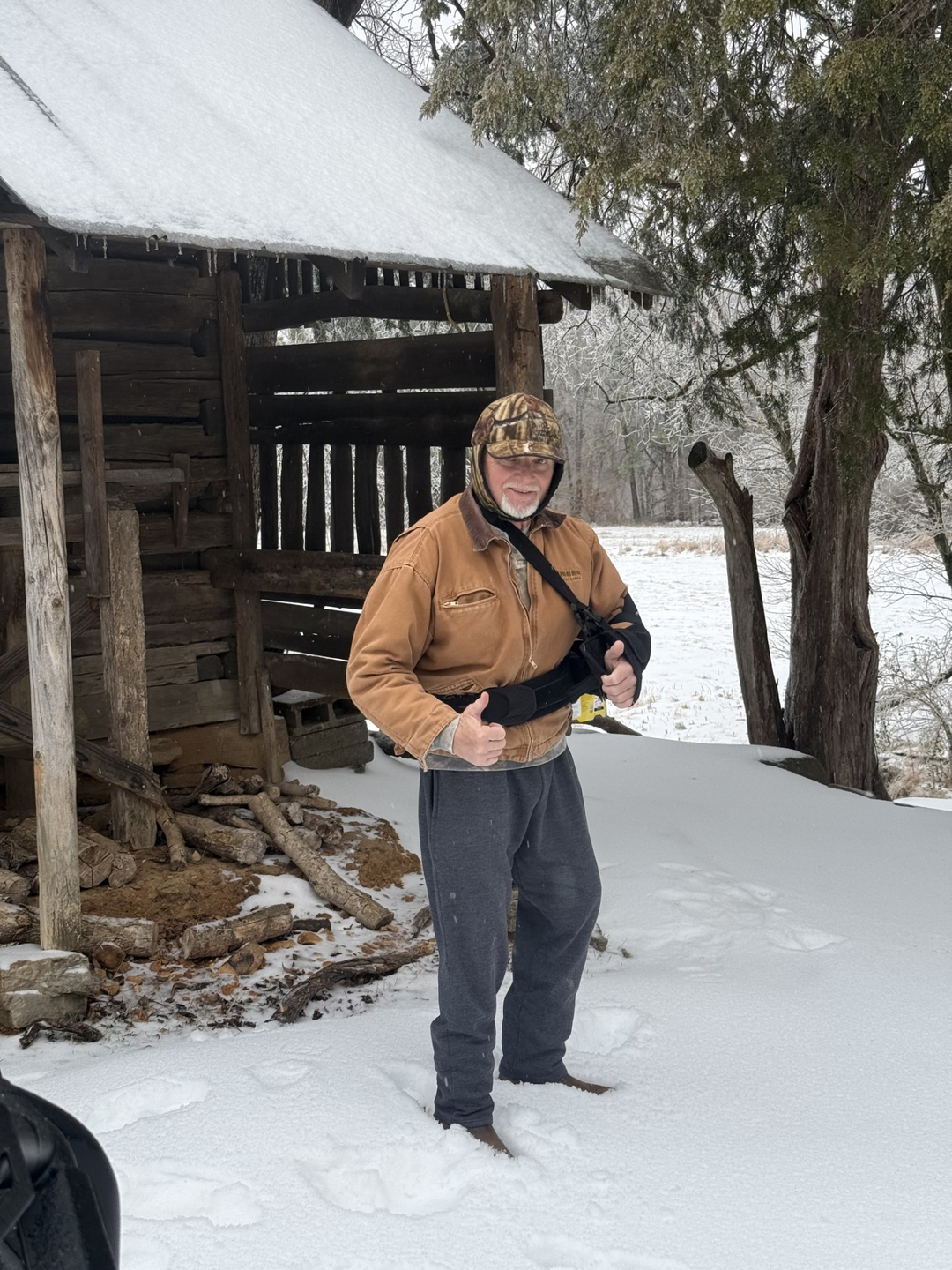 Roy Hinson outside after snowfall, giving a thumbs-up gesture.