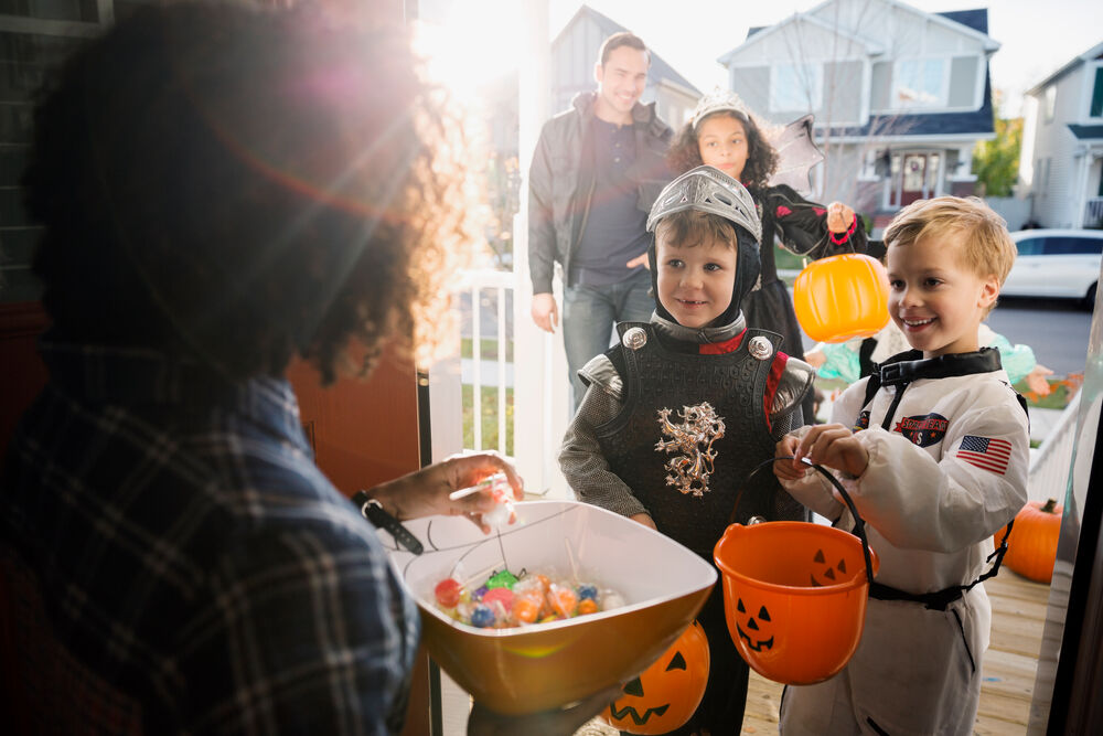Kids getting candy while their parent looks on.
