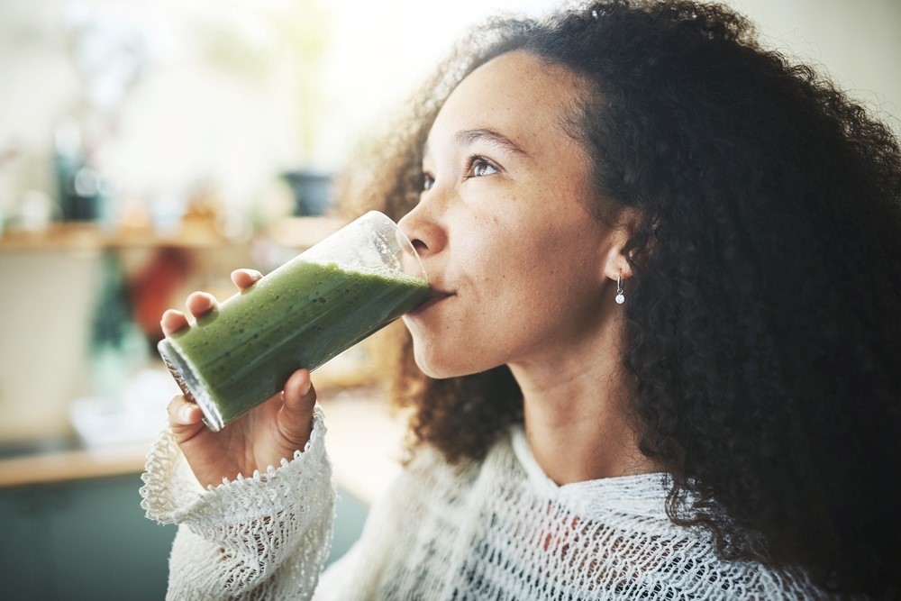 A woman drinks from a glass