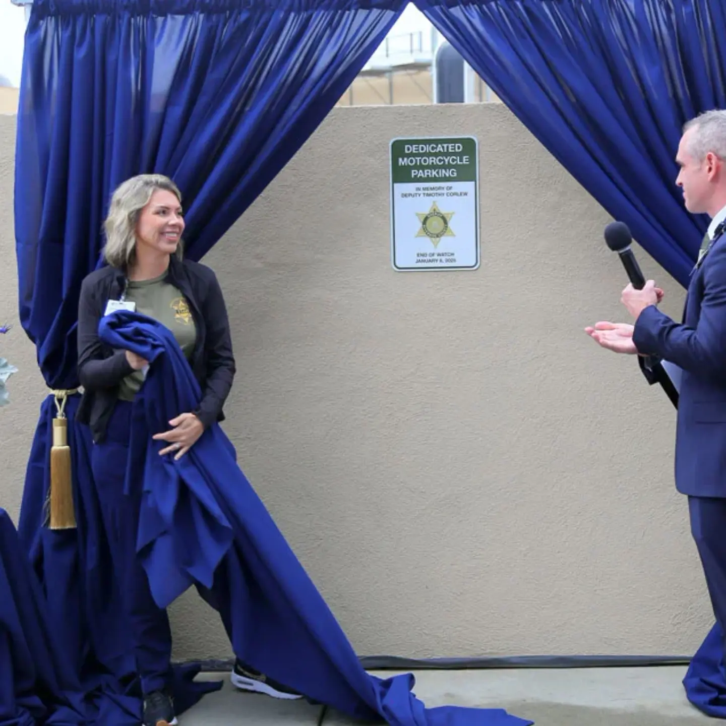 Lacey Page smiles while talking with Peter Hemstead during a commemorative plaque unveiling for Sheriff Deputy Timothy Corlew.