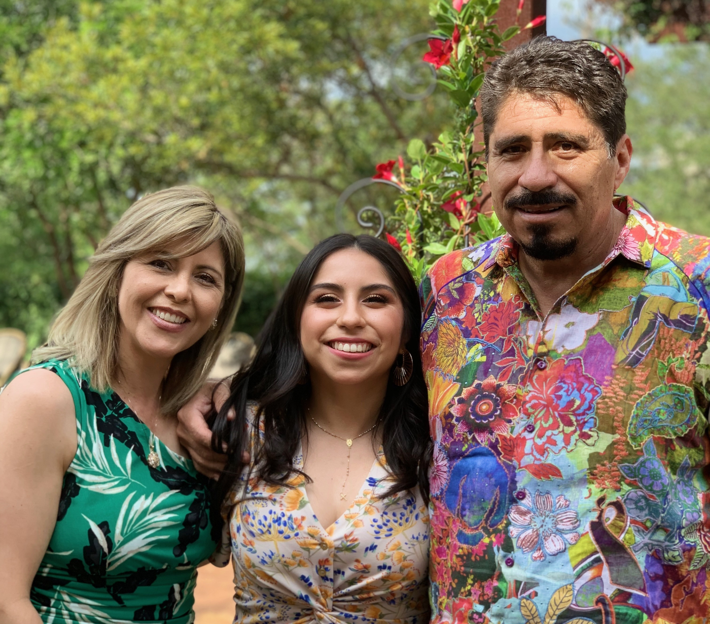 Aracely Castro standing with her parents