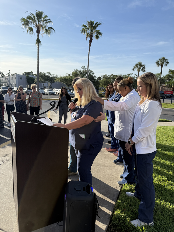 A woman speaks to all in attendance at the celebration nurse Tara McClintock's life.
