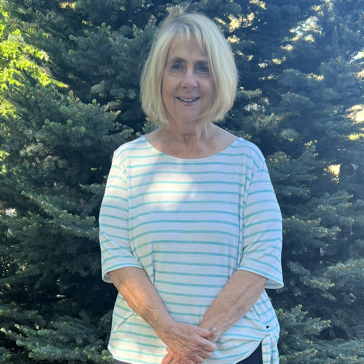 Barb, posing in her front yard after weight loss surgery at Rose Medical Center.