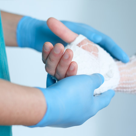 A closeup of a hand being wrapped in a bandage.