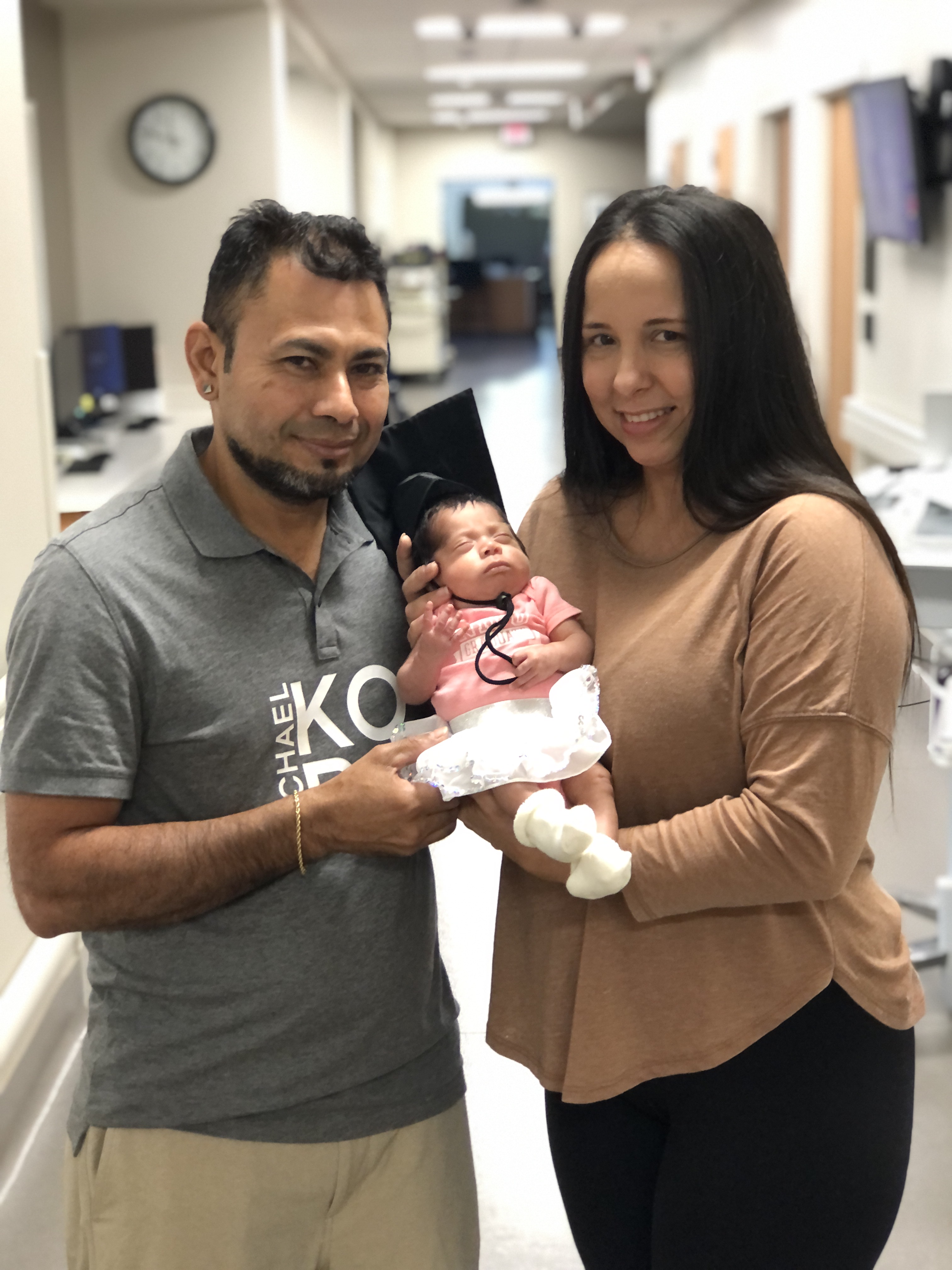 Gloria and Carlos Ramirez pose with their baby, Mia.