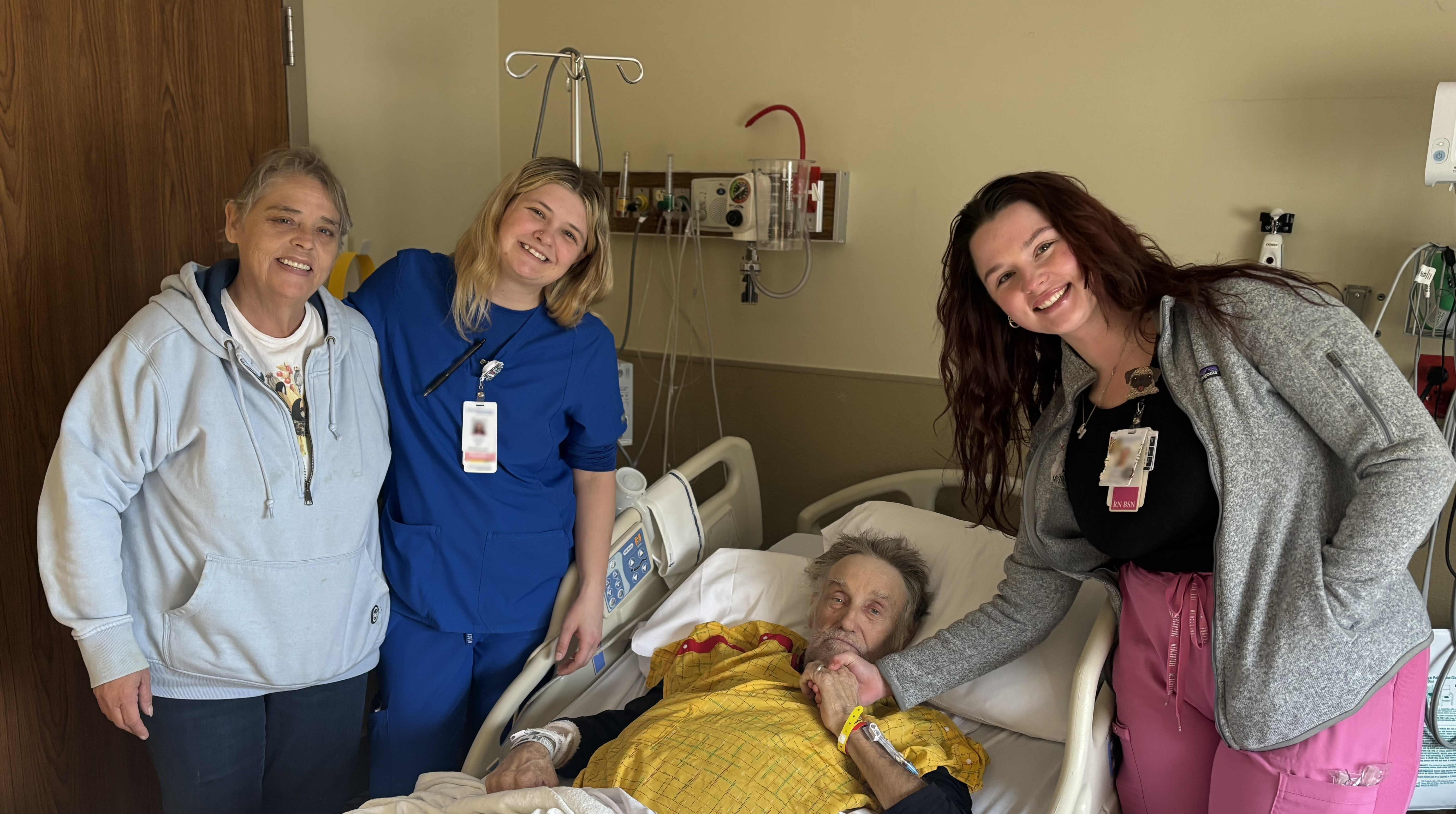 Photo of Roger, his wife, and his care team.
