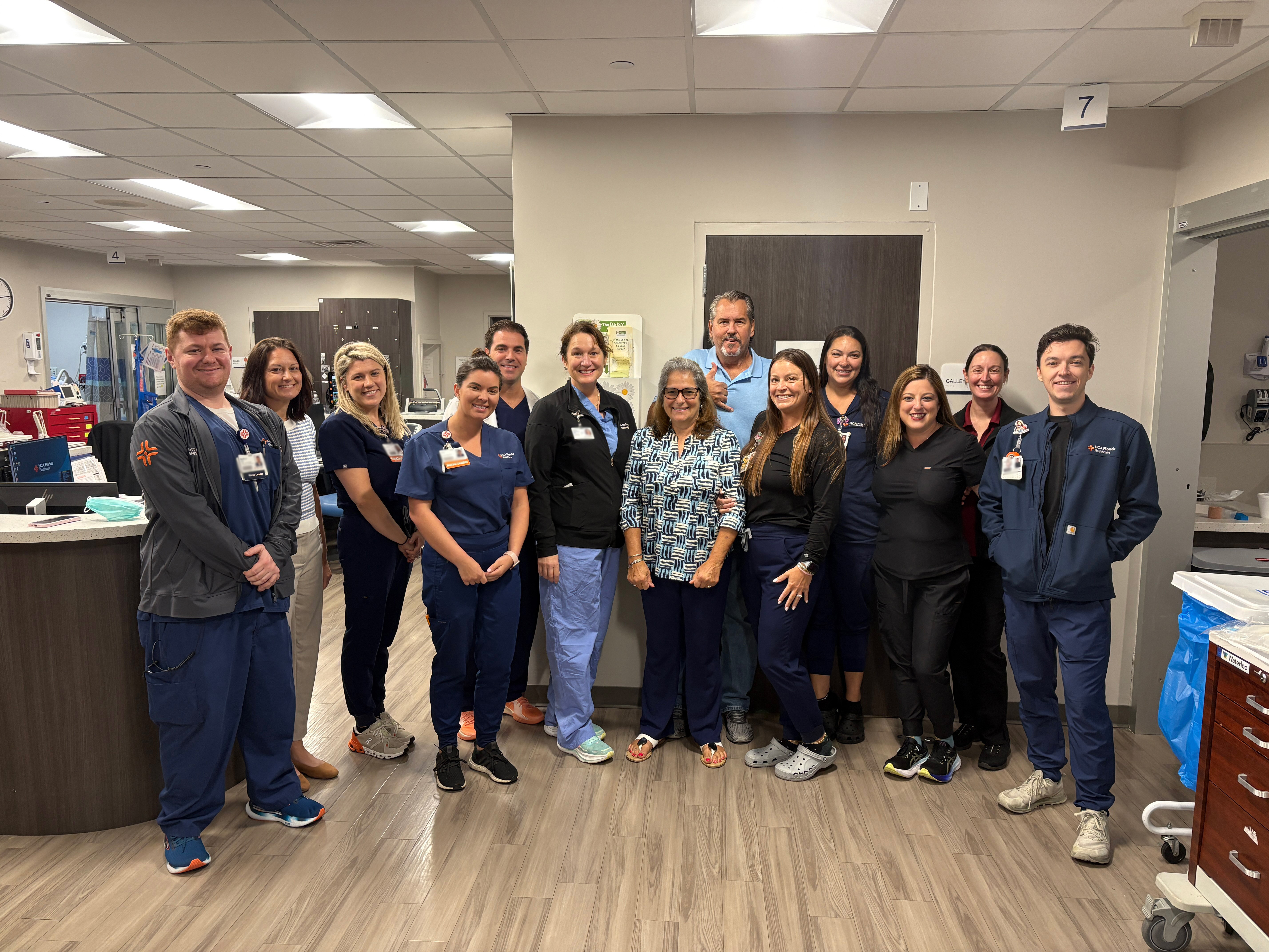 Patient with ICU team surrounding her.