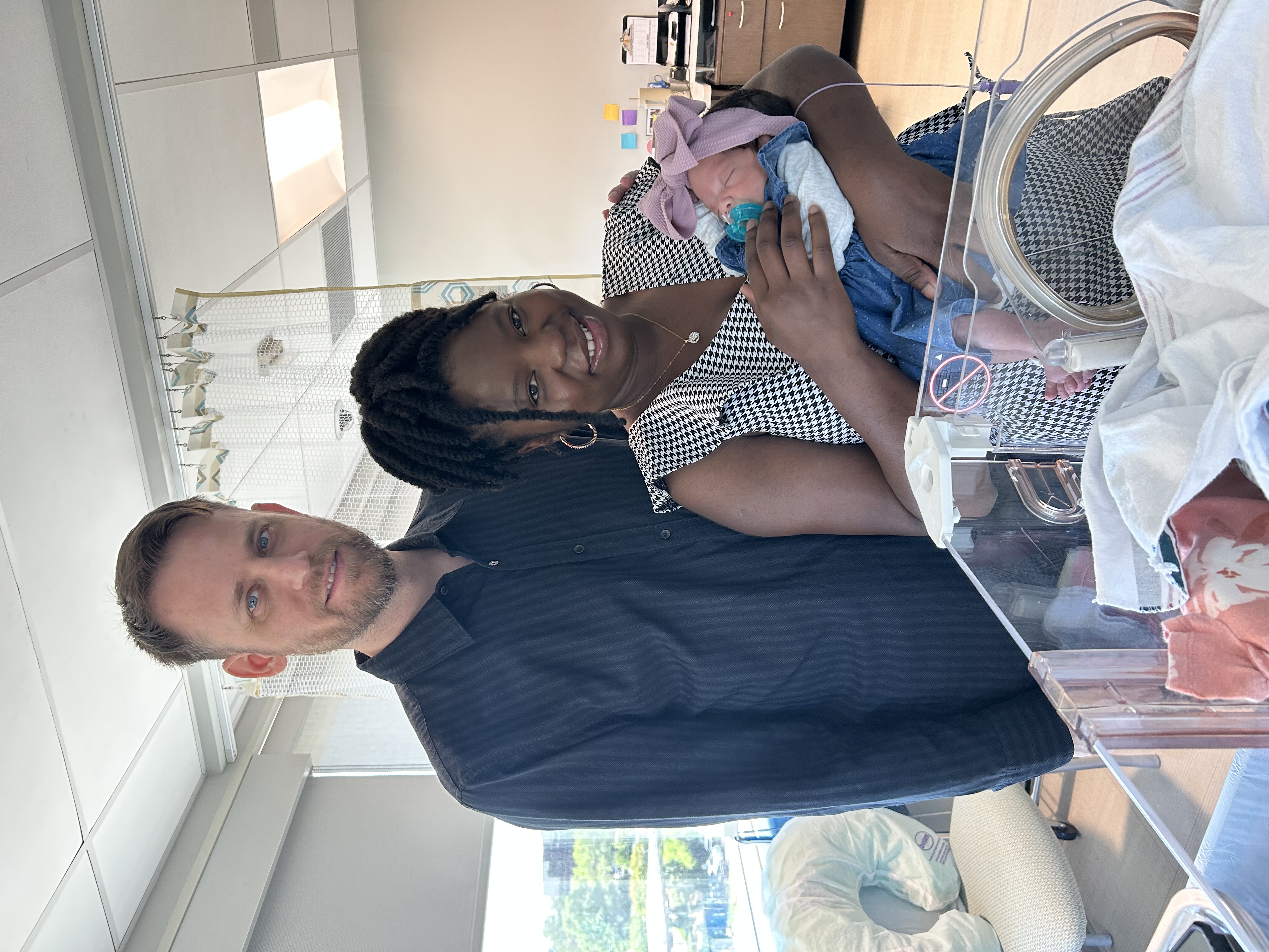 Diana and Chris Flowers holding their baby.