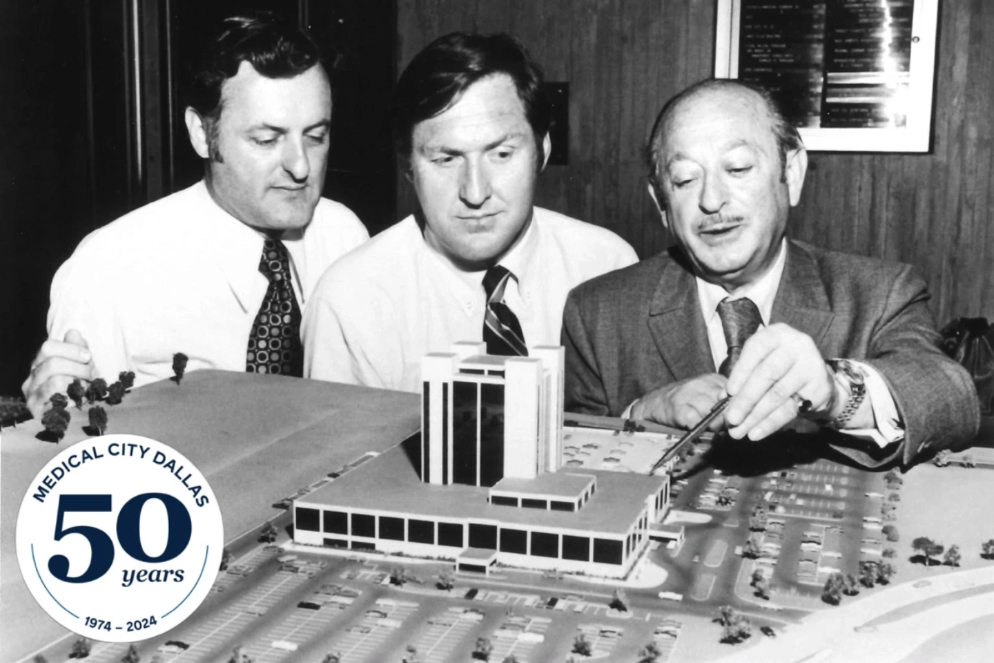 Developers looking at a model of the Medical City Healthcare hospital.