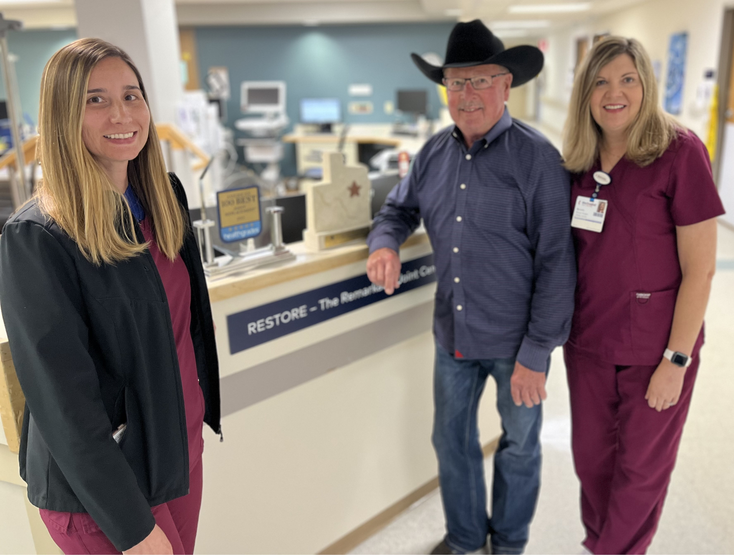 Patient standing next to 2 Rehab specialists
