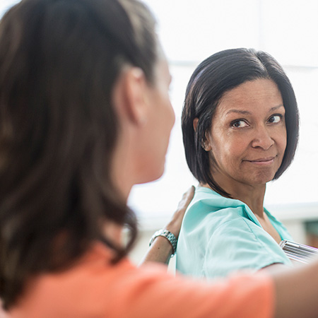 Two women looking at each other.
