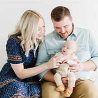 Spencer and Megan Synder are seated with baby Crew. 