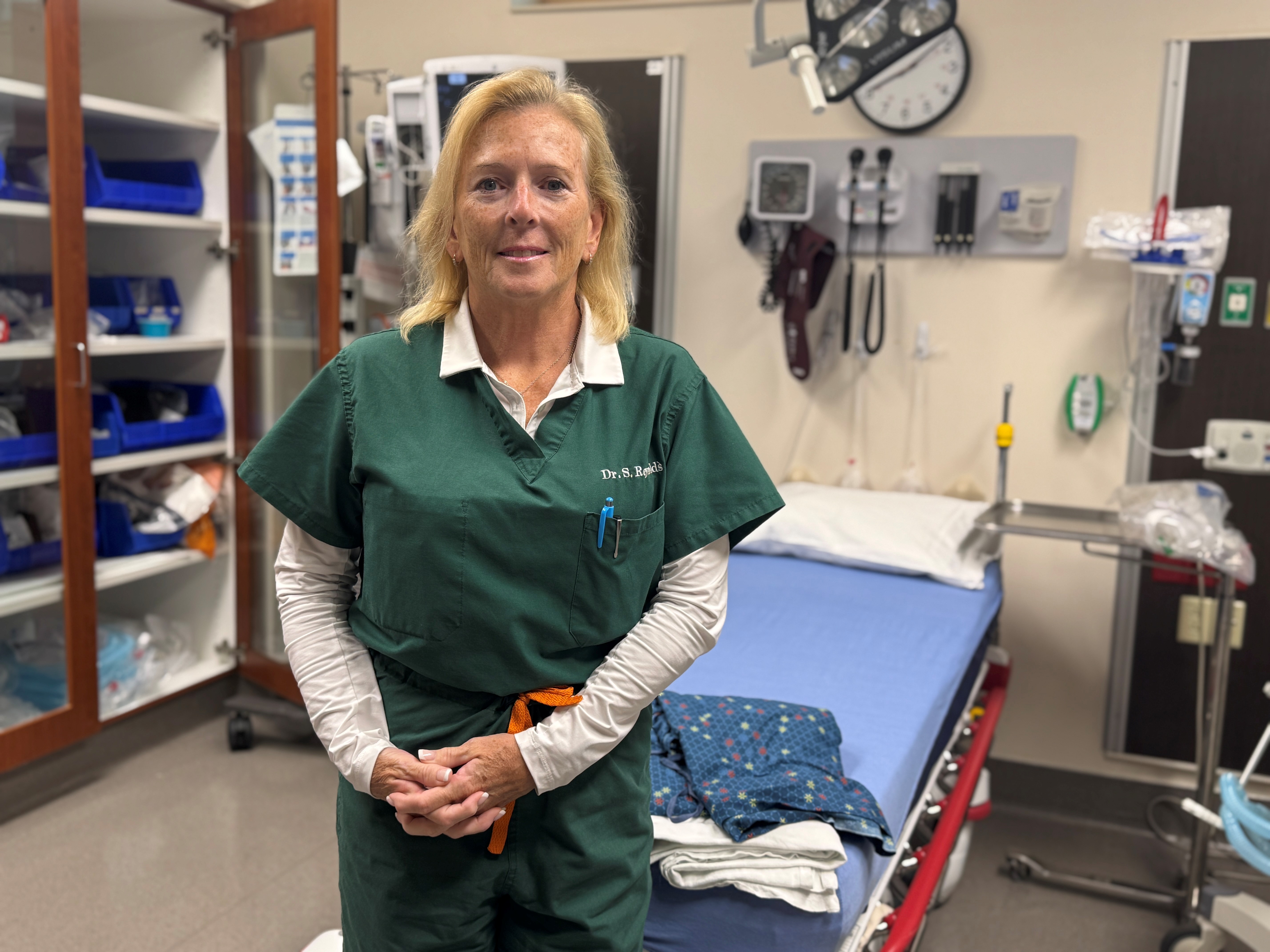 Dr Stephanie Reynolds stands in emergency room.