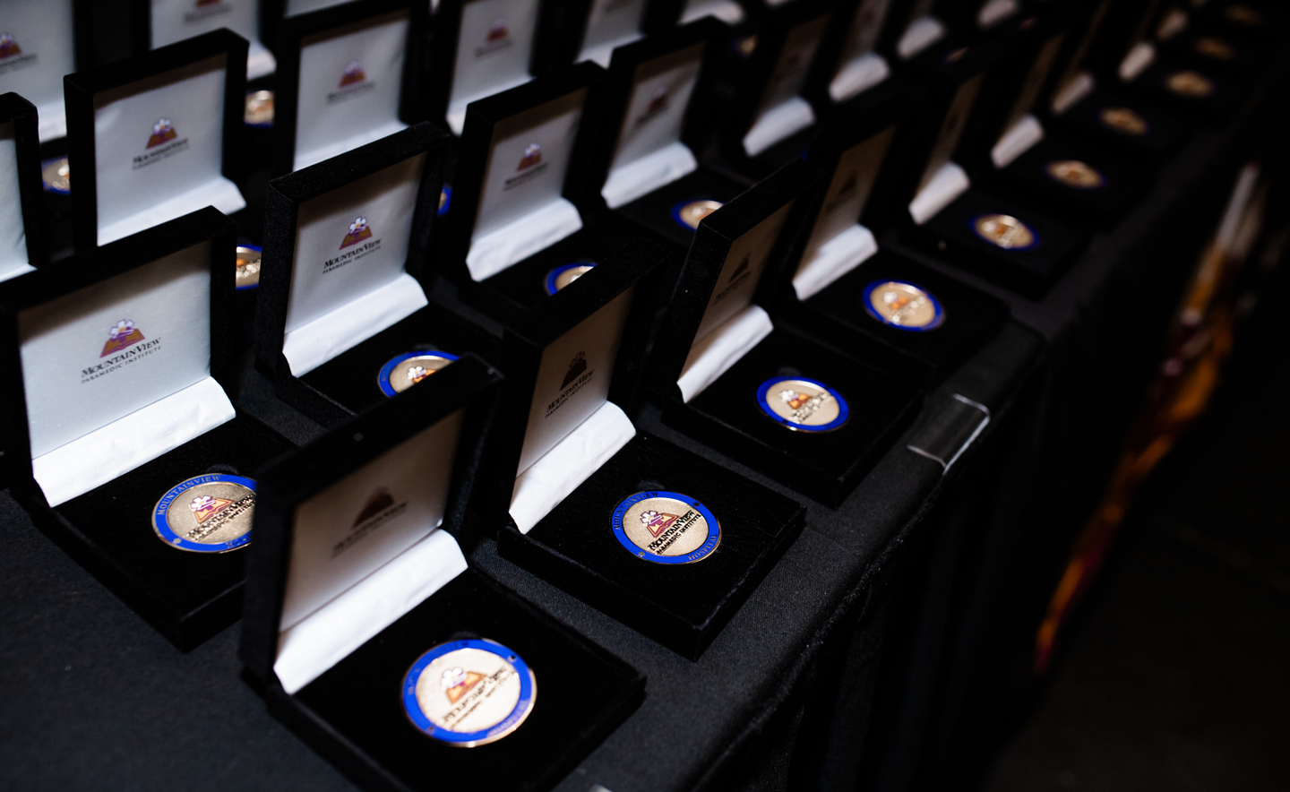 Photo of multiple graduation medals in opened boxes.