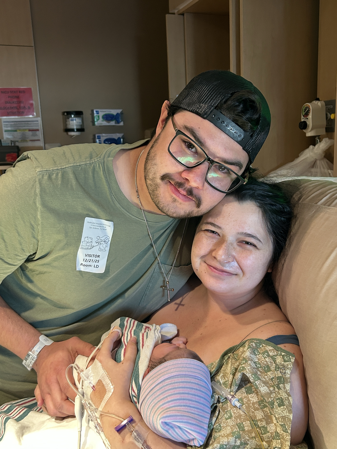 Photo showing of Hannah Carmony  a patient of Methodist Hospital Stone Oak and her husband, holding their newborn baby and smiling for a picture.