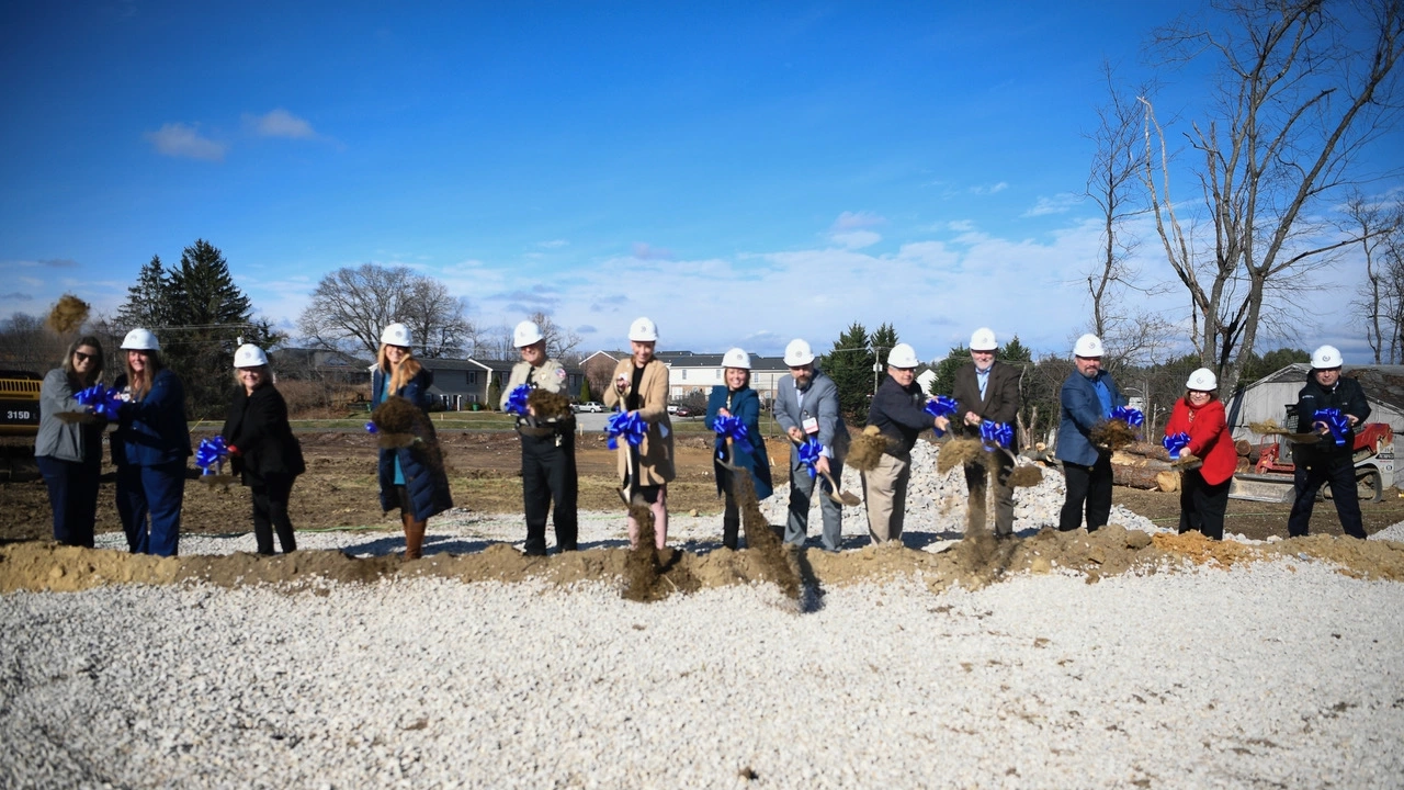 Hospital staff pose with hardhats and shovels.