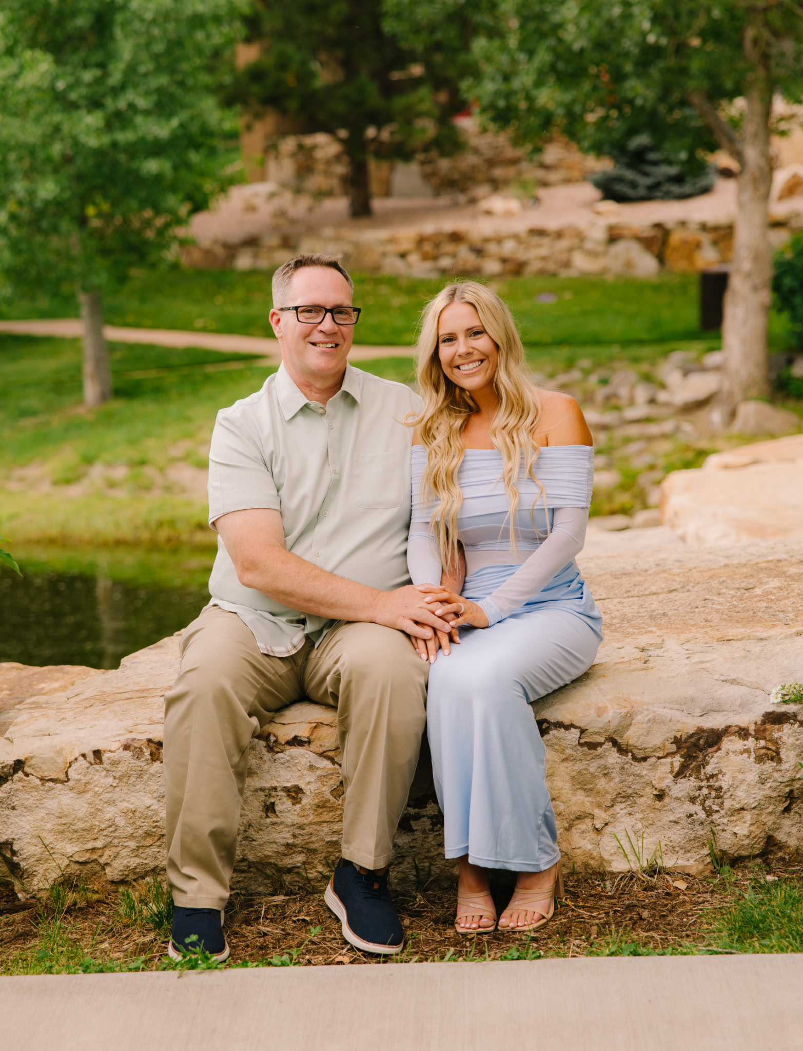 Russell McKeehan with sitting with daughter in a scenic park.