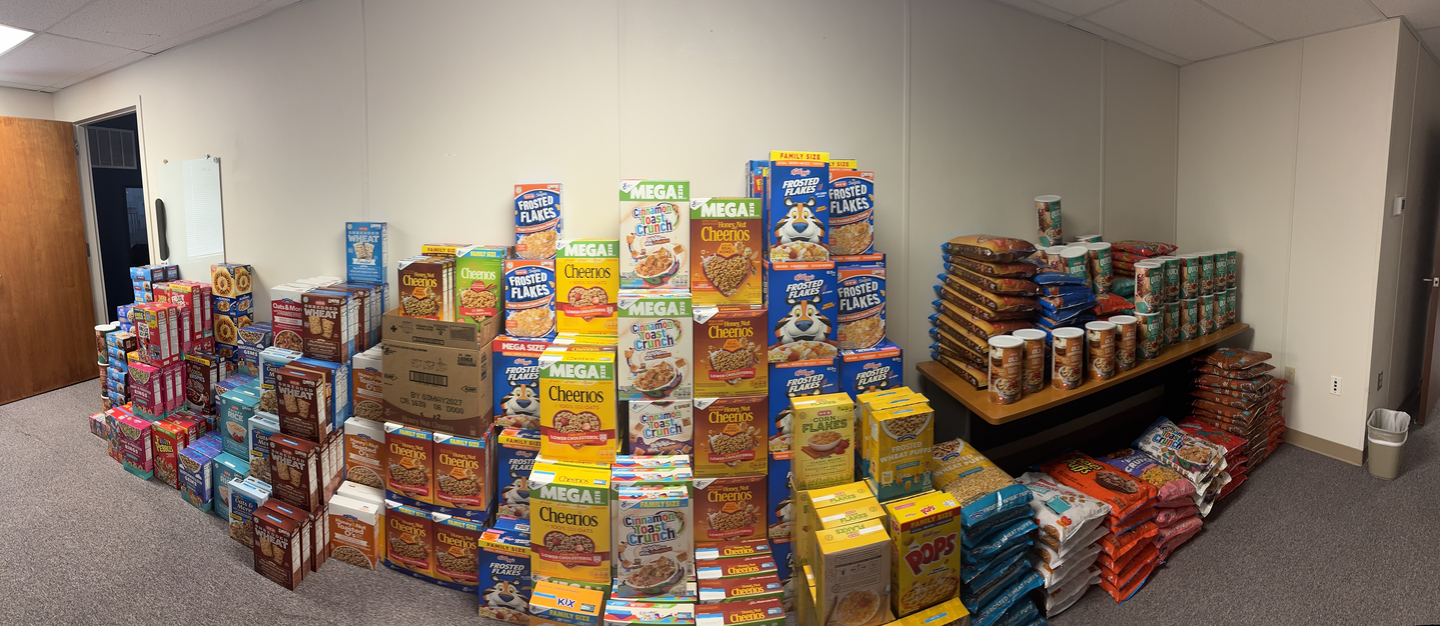 Donated cereal in a hallway stacked up high.