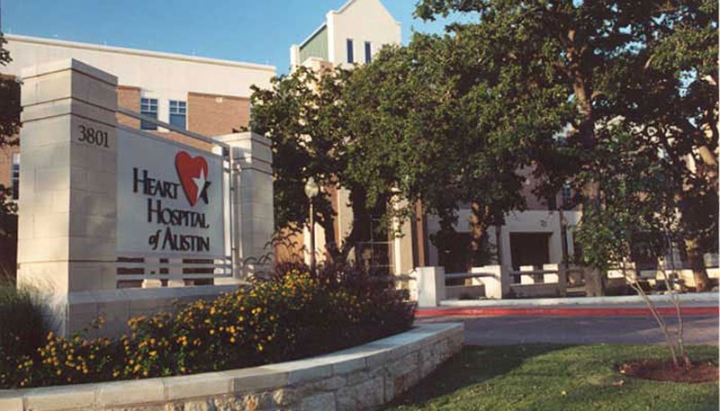 Exterior main entrance of the Heart Hospital of Austin on a sunny day.