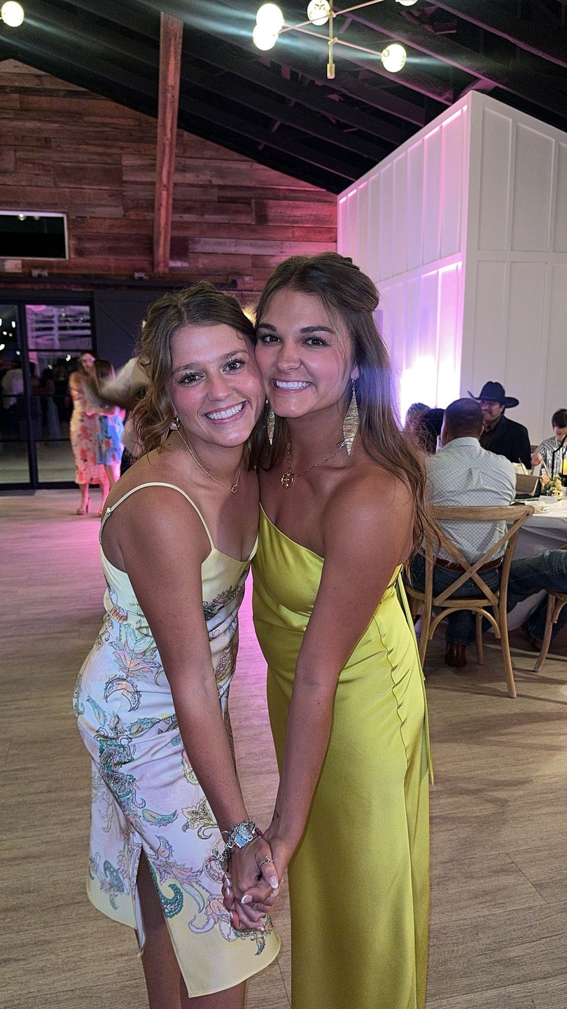 Photo showing of two sister Brynn and Madison Rodgers, posing and smiling during a party.