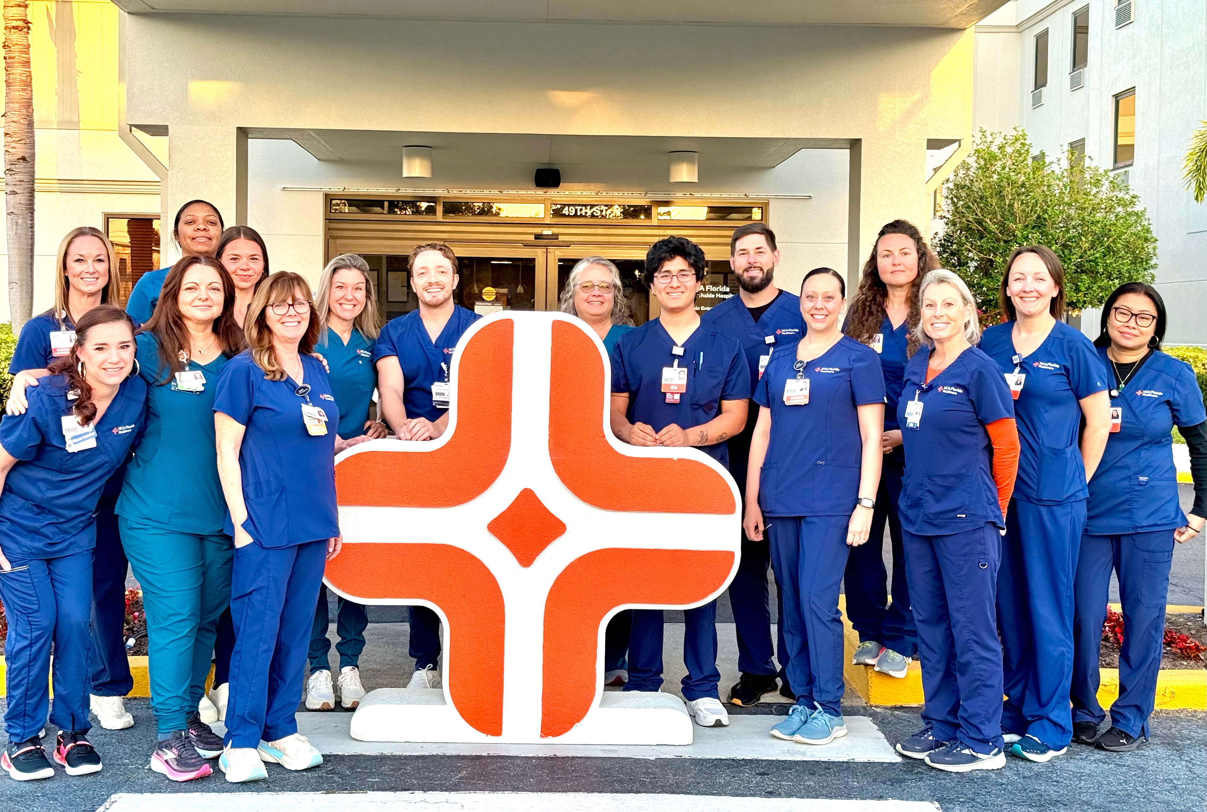 HCA Florida Northside orthopedic care team pose for a photo next to the HCA Healthcare symbol.