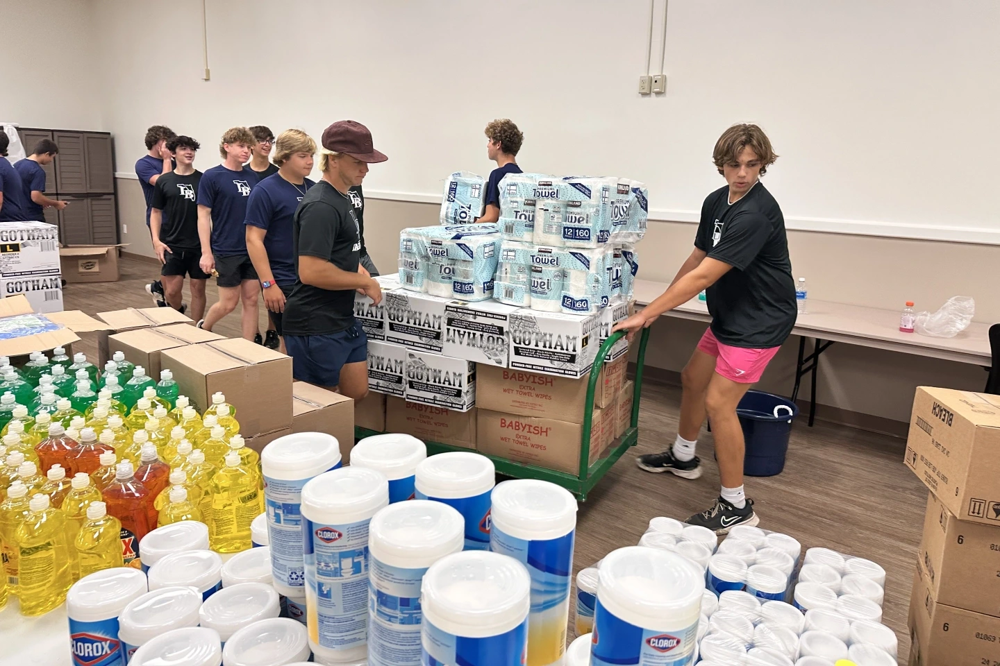 Pallets of baby formula, gloves and paper towels were staged by the Lemon Bay High School baseball players helped to set up the mini-mart supplies.