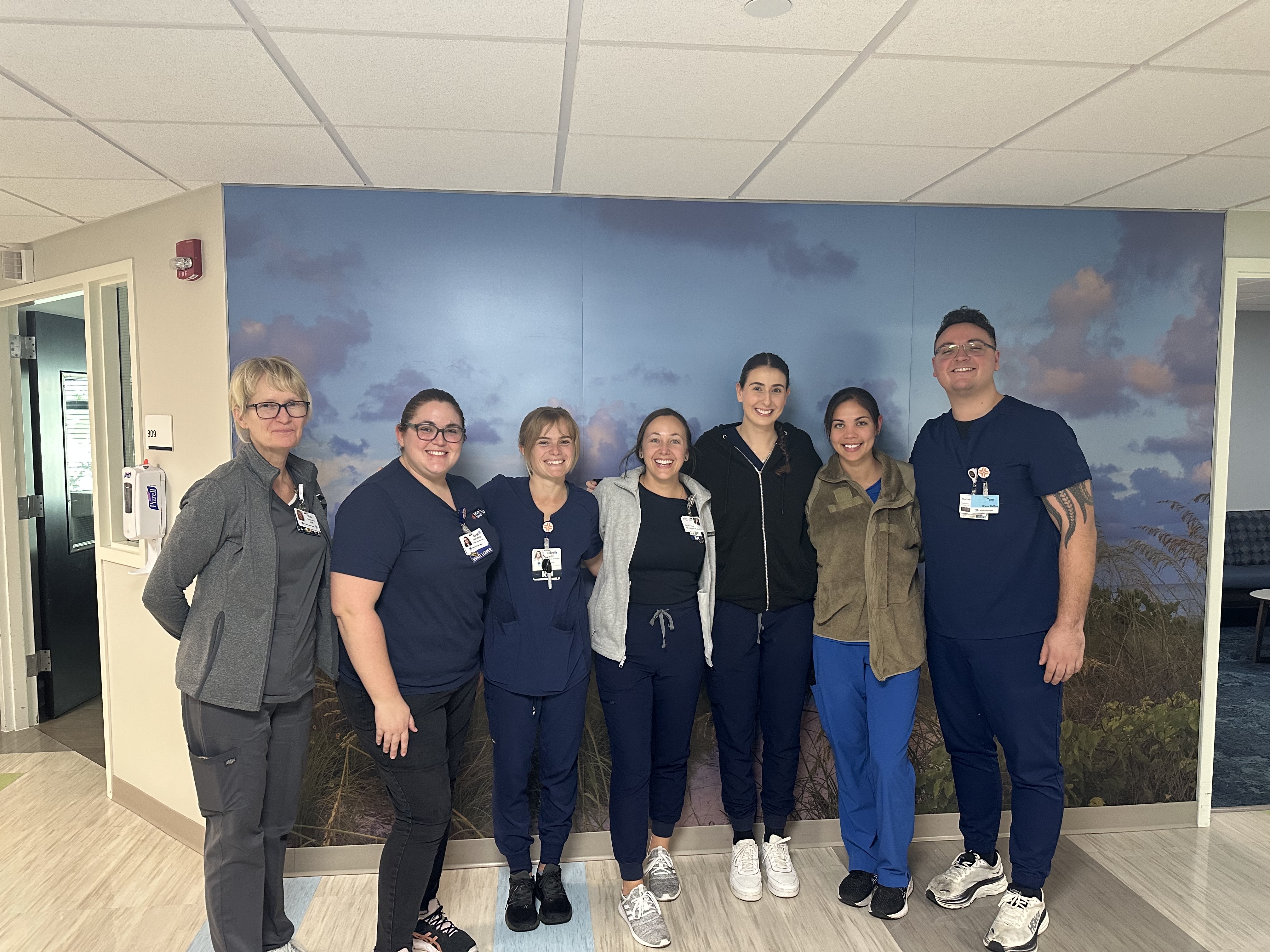 Group of healthcare providers standing inside the hospital hall.