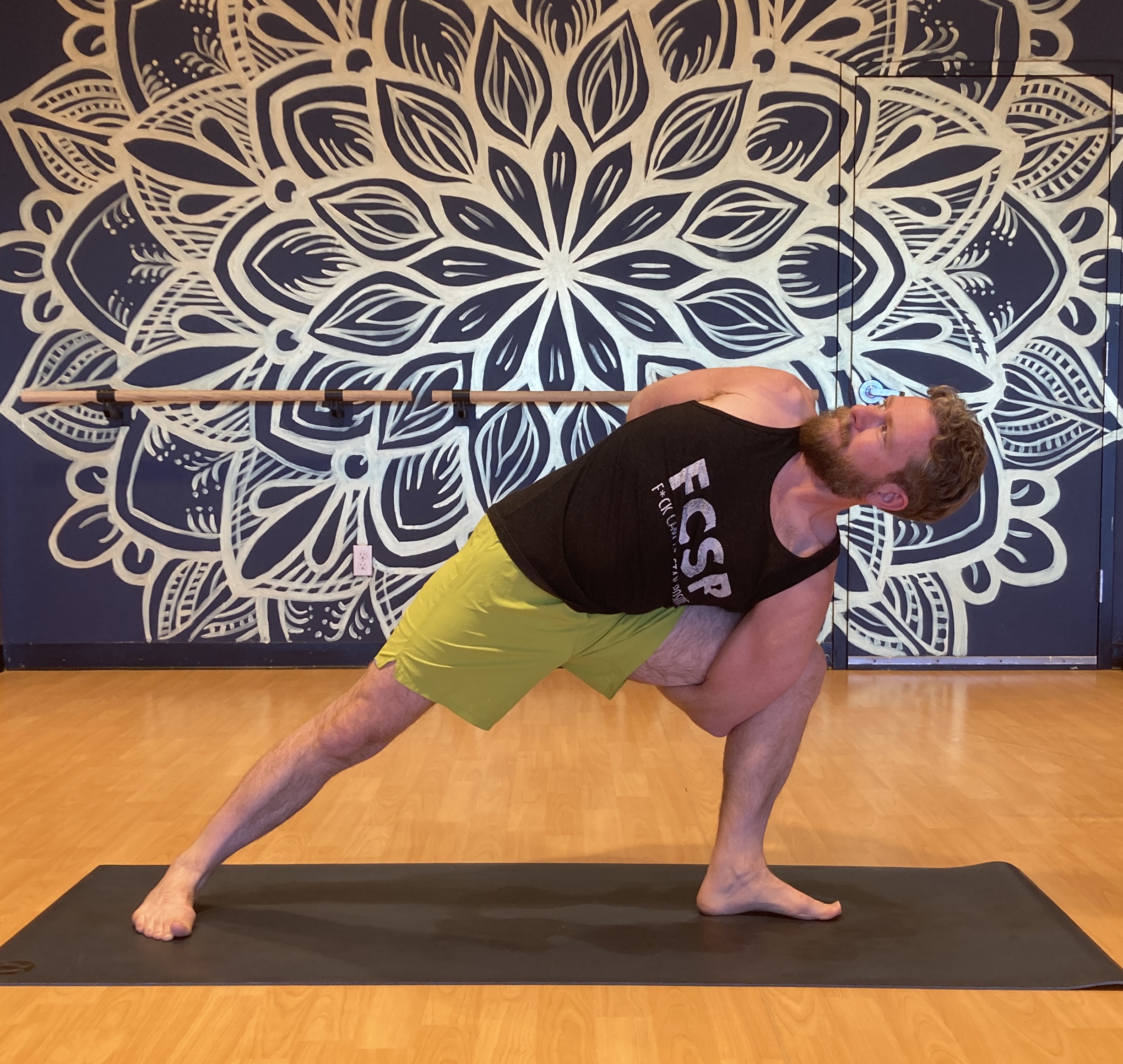 Troy practicing yoga with his custom prosthetic