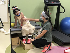 Anabela’s father spots her during a rehabilitation exercise.