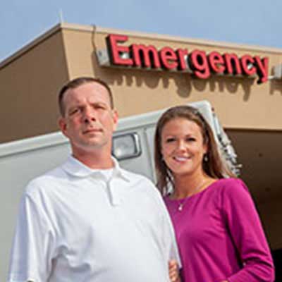 Rich and Allison Murphy smiling, stand outside of the ER at Doctors Hospital of Augusta.