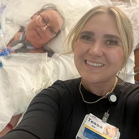 Lori, in her hospital bed, with her nurse Tessa.