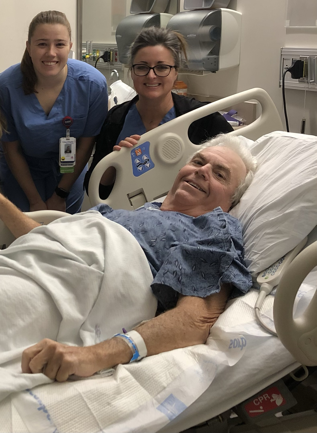 David Johnson smiles as his care providers look on.